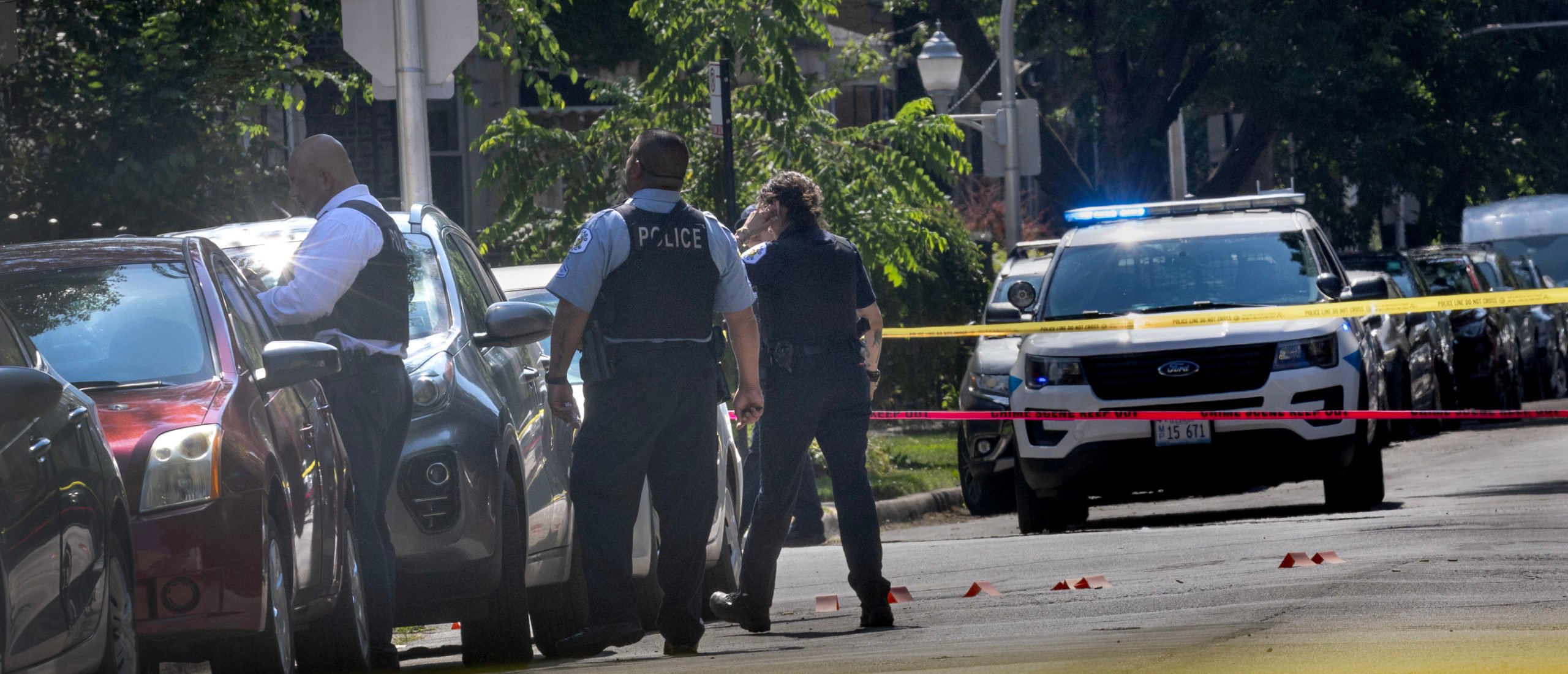 Police investigate the scene of a drive-by shooting on July 06, 2024 in Chicago, Illinois. At least 103 people were shot, 19 fatally, in gun violence in the city over the long Fourth of July holiday weekend. (Photo by Scott Olson/Getty Images)