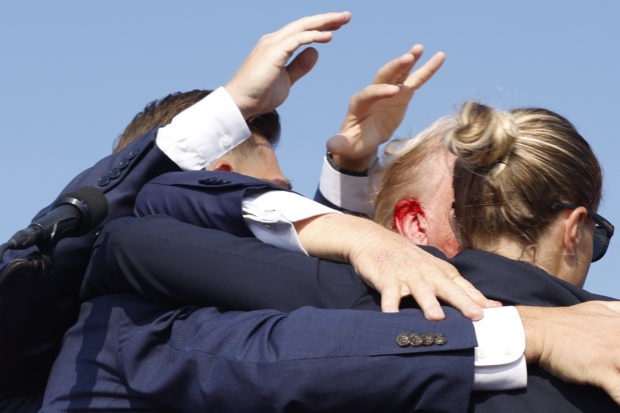 BUTLER, PENNSYLVANIA - JULY 13: Republican presidential candidate former President Donald Trump is rushed offstage during a rally on July 13, 2024 in Butler, Pennsylvania. Butler County district attorney Richard Goldinger said the shooter is dead after injuring former U.S. President Donald Trump, killing one audience member and injuring another in the shooting. (Photo by Anna Moneymaker/Getty Images)