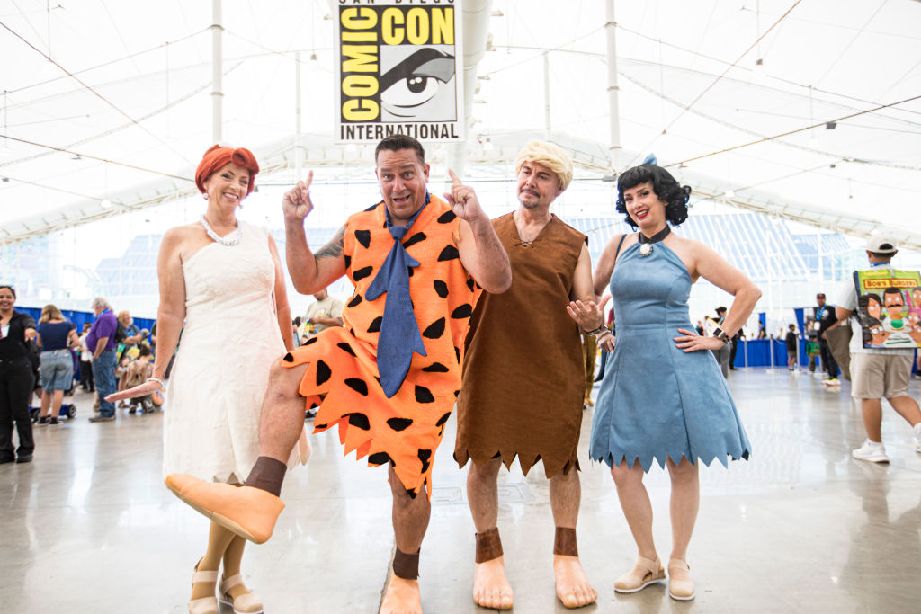 SAN DIEGO, CALIFORNIA - JULY 28: (L-R) Flintstone cosplayers Shelly Grace as Wilma, Ed Gonzalez as Fred, Miguel Capuchino as Barney, and Lucy Capuchino as Betty pose on Day 4 of 2024 Comic-Con International on July 28, 2024 in San Diego, California. (Photo by Daniel Knighton/Getty Images)