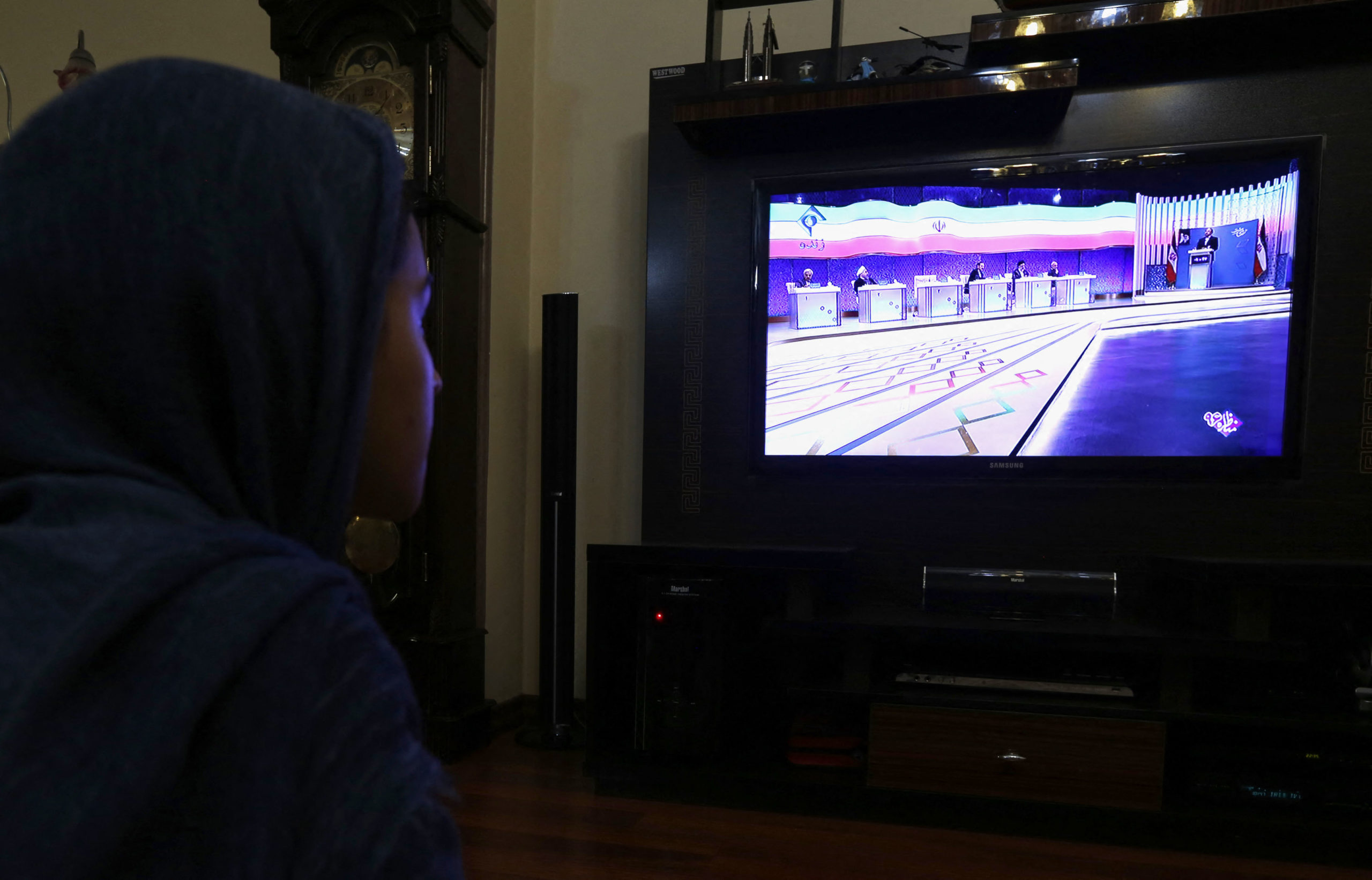 An Iranian woman watches the six presidential candidates for Iran's elections attending a live debate on state TV in Tehran on April 28, 2017.. Iran will air live debates on state television ahead of May's presidential election, the interior ministry, reversing a decision to show recorded versions that had triggered an outcry. (Photo by ATTA KENARE/AFP via Getty Images)