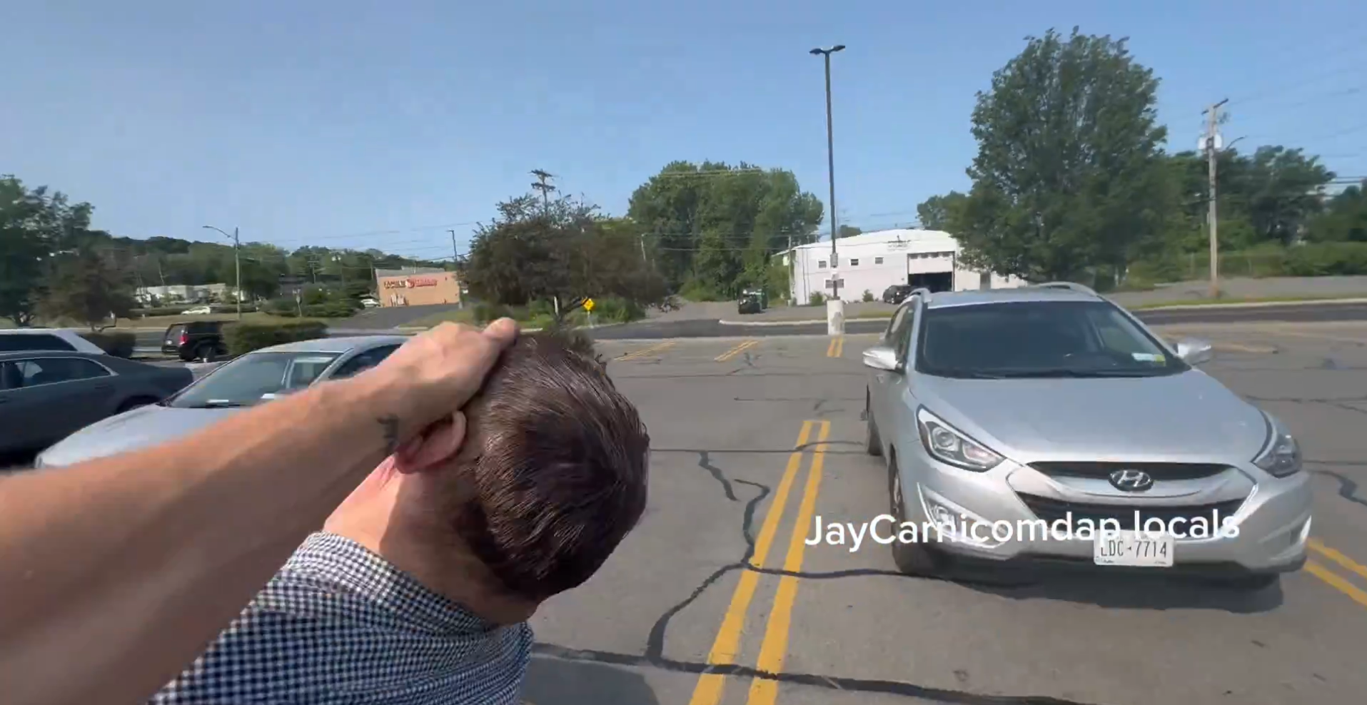 Dads Against Predators smack a sting operation target in a parking lot. Screenshot/Twitter/@jaycarnicomdap