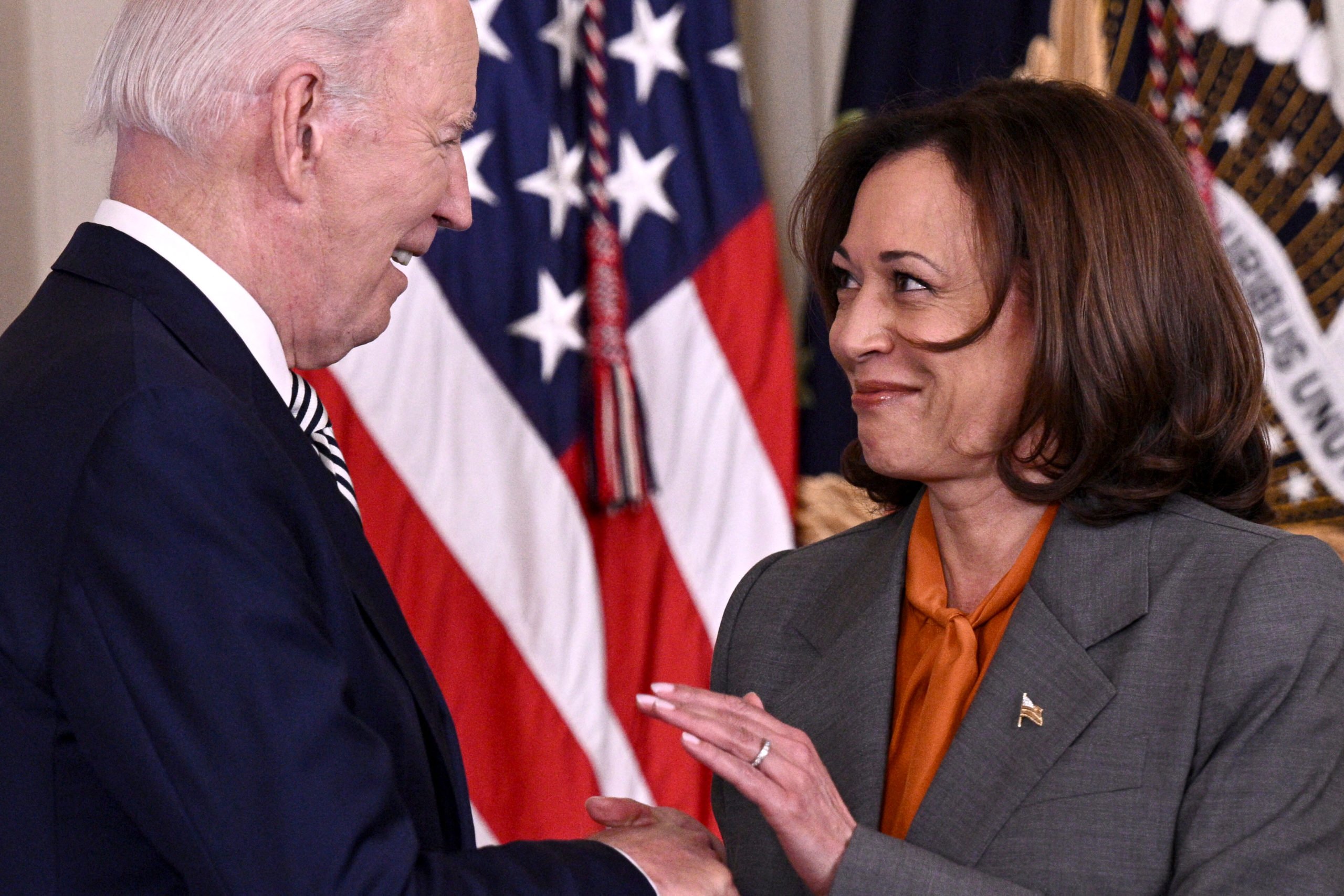 TOPSHOT - US President Joe Biden shakes hands with US Vice President Kamala Harris prior to delivering remarks on advancing the safe, secure, and trustworthy development and use of artificial intelligence, in the East Room of the White House in Washington, DC, on October 30, 2023. Biden issued an executive order October 30, 2023, on regulating artificial intelligence, aiming for the United States to "lead the way" in global efforts at managing the new technology's risks, the White House said. The "landmark" order directs federal agencies to set new safety standards for AI systems and requires developers to "share their safety test results and other critical information with the US government," according to a White House statement. (Photo by BRENDAN SMIALOWSKI/AFP via Getty Images)