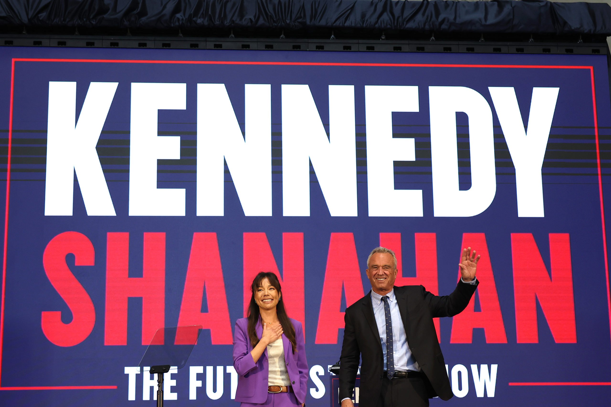 OAKLAND, CALIFORNIA - MARCH 26: Independent presidential candidate Robert F. Kennedy Jr. (R) and his vice presidential pick Nicole Shanahan take the stage during a campaign event to announce his pick for a running mate at the Henry J. Kaiser Event Center on March 26, 2024 in Oakland, California. Nicole Shanahan is an attorney and tech entrepreneur based in the San Francisco Bay Area. (Photo by Justin Sullivan/Getty Images)