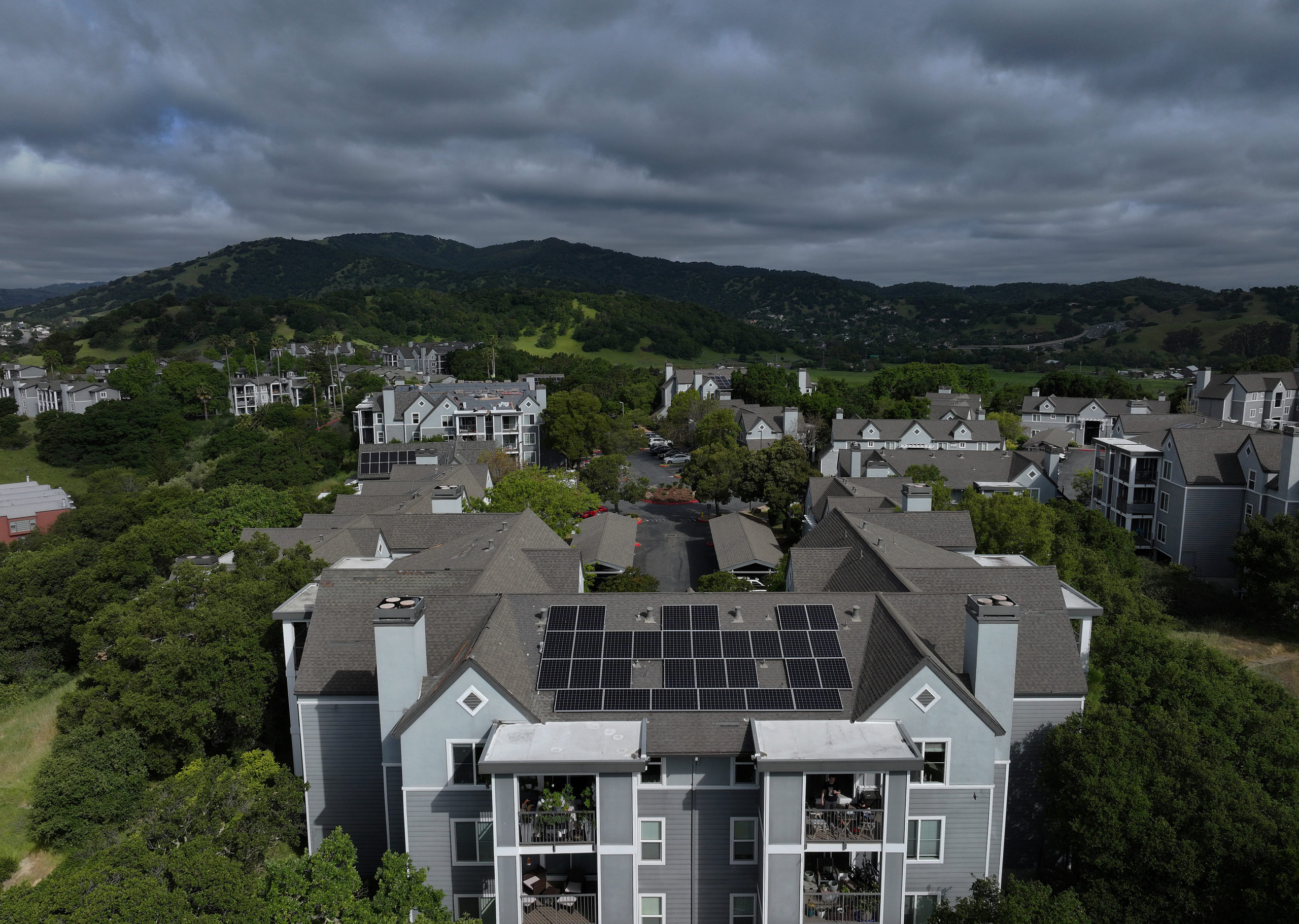 SAN RAFAEL, CALIFORNIA - APRIL 25: In an aerial view, solar panels are seen on the roof of an apartment complex on April 25, 2024 in San Rafael, California. California has cut back on rooftop solar incentives as the state has an estimated 47 gigawatts of solar power installed, nearly 25 percent of the state's electricity, that powers 13.9 million homes. On days where there is little demand for electricity, the price of electricity flattens and gigawatts of the solar generated power is curtailed. (Photo by Justin Sullivan/Getty Images)