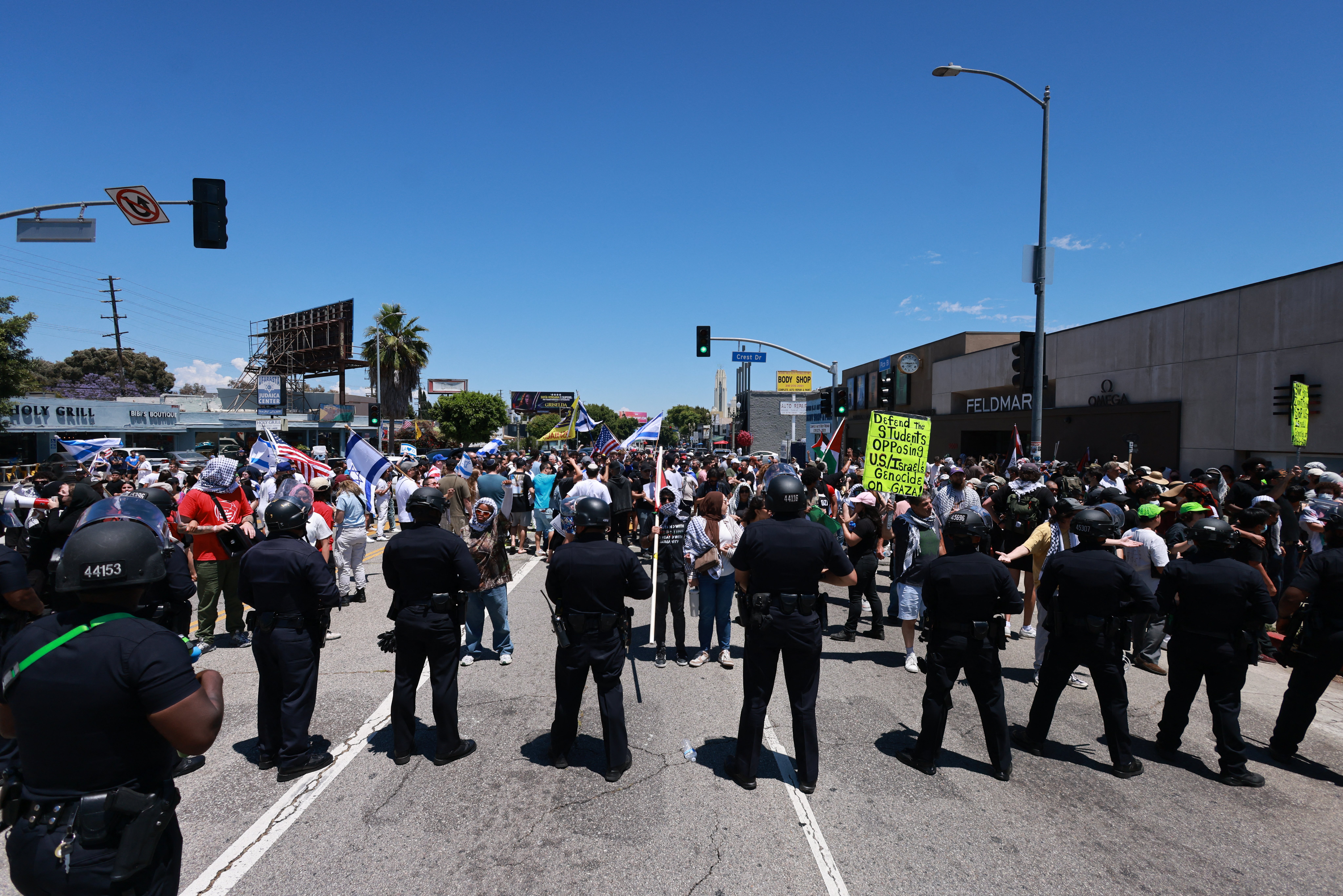 Los Angeles Police Department (LAPD) officers line up in front of anti-Israel protesters gathered outside the Adas Torah Orthodox Jewish synagogue in Los Angeles, June 23, 2024. (Photo by DAVID SWANSON / AFP) (Photo by DAVID SWANSON/AFP via Getty Images)