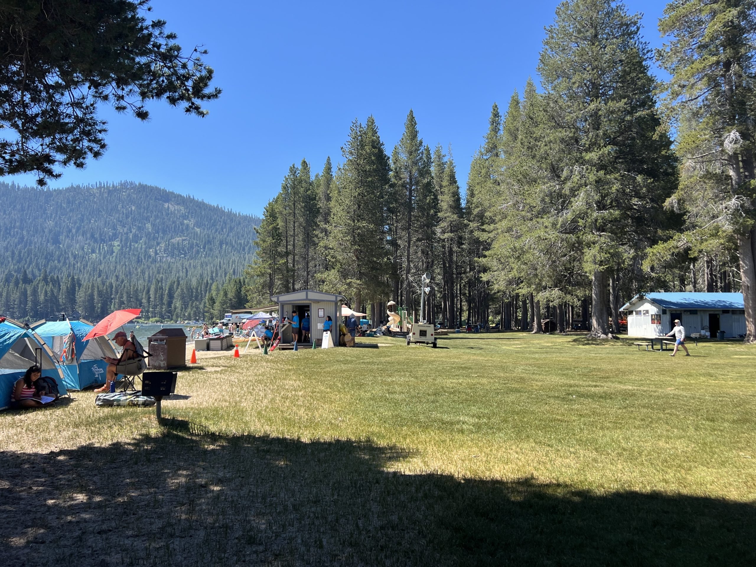 Campsite with tents, picnic areas, and nearby lake under clear blue sky at West End Beach, Truckee, California, July 5, 2024. (Photo by Smith Collection/Gado/Getty Images)