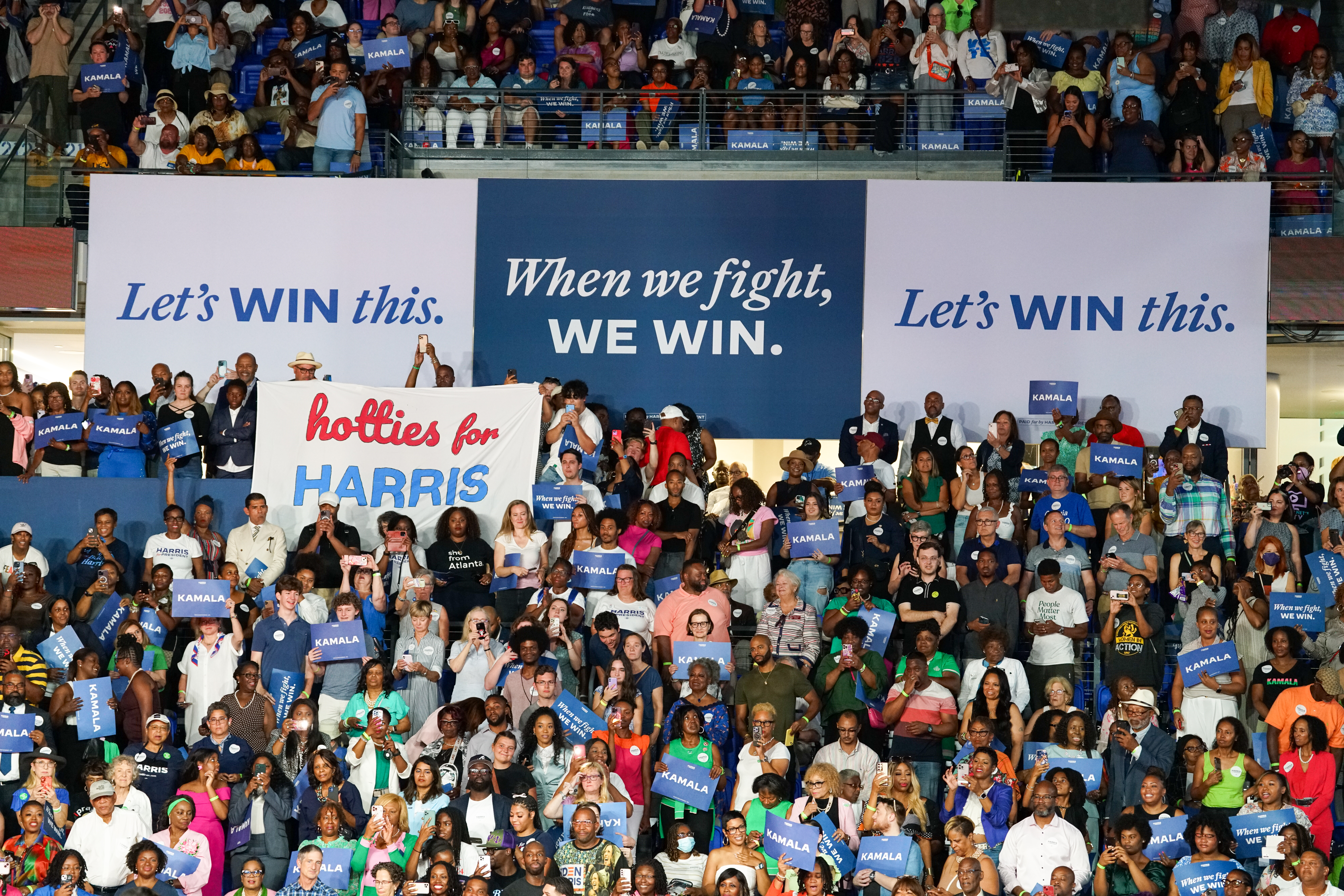 Fans hold a "Hotties for Harris" sign during a Megan Thee Stallion performance at a campaign rally for Democratic presidential candidate, U.S. Vice President Kamala Harris at Georgia State Convocation Center on July 30, 2024 in Atlanta, Georgia. (Photo by Julia Beverly/Getty Images)