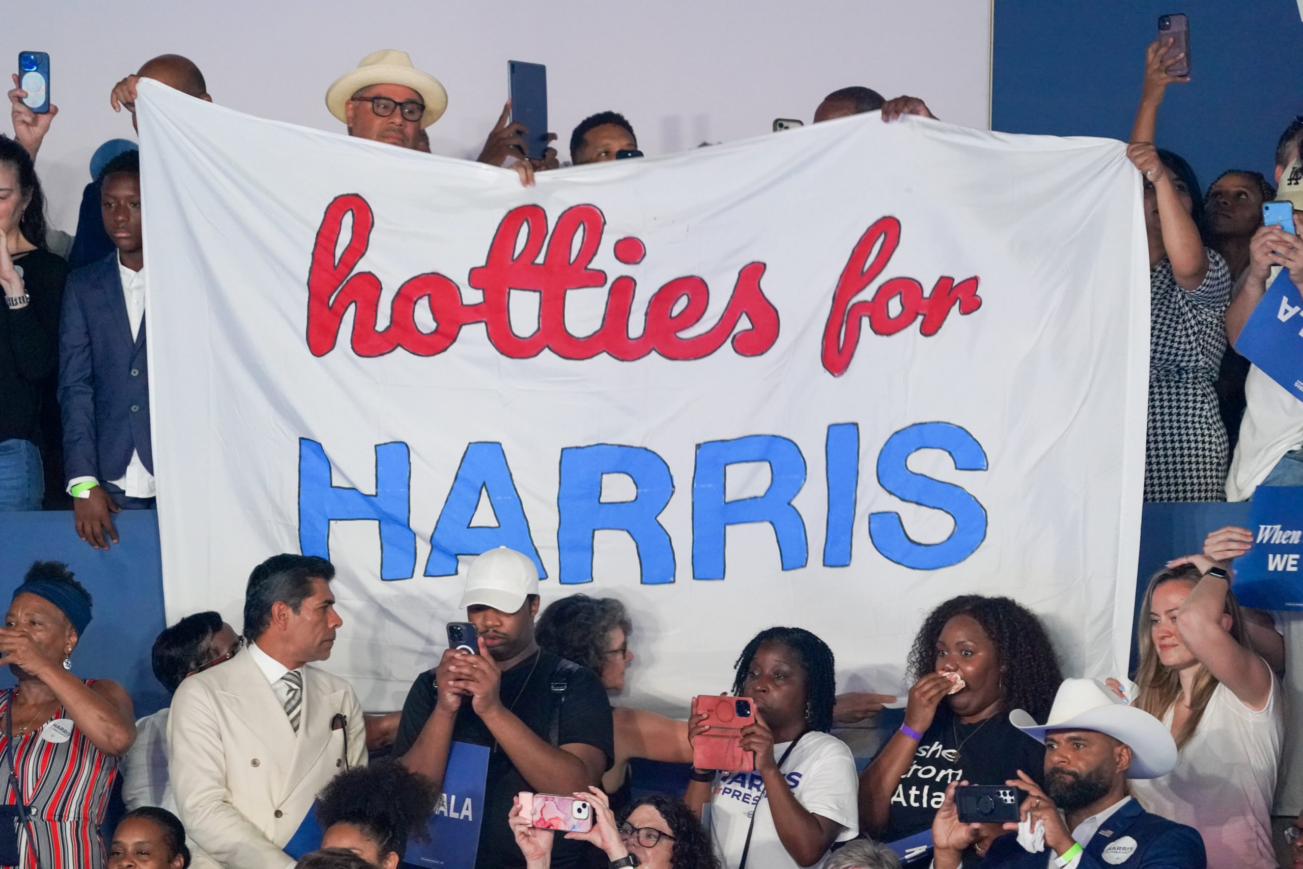 Fans hold a "Hotties for Harris" sign while Megan Thee Stallion performs at a campaign rally for Democratic presidential candidate, U.S. Vice President Kamala Harris at the Georgia State Convocation Center on July 30, 2024 in Atlanta, Georgia. (Photo by Julia Beverly/Getty Images)