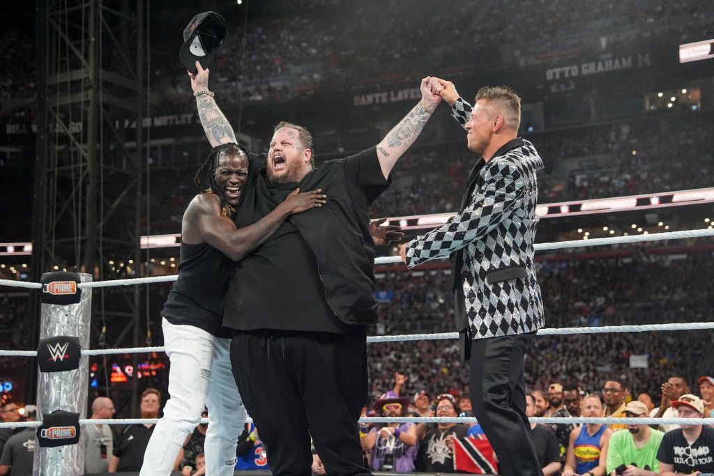 CLEVELAND, OHIO - AUGUST 03: Jelly Roll celebrates with R-Truth and Miz during SummerSlam at Cleveland Browns Stadium on August 3, 2024 in Cleveland, Ohio. (Photo by WWE/Getty Images)