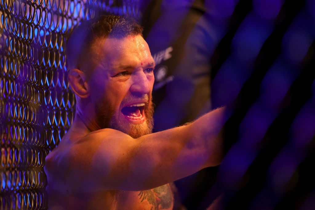 LAS VEGAS, NEVADA - JULY 10: Conor McGregor of Ireland sits on the mat after injuring his ankle in the first round in his lightweight bout against Dustin Poirier during UFC 264: Poirier v McGregor 3 at T-Mobile Arena on July 10, 2021 in Las Vegas, Nevada. (Photo by Stacy Revere/Getty Images)