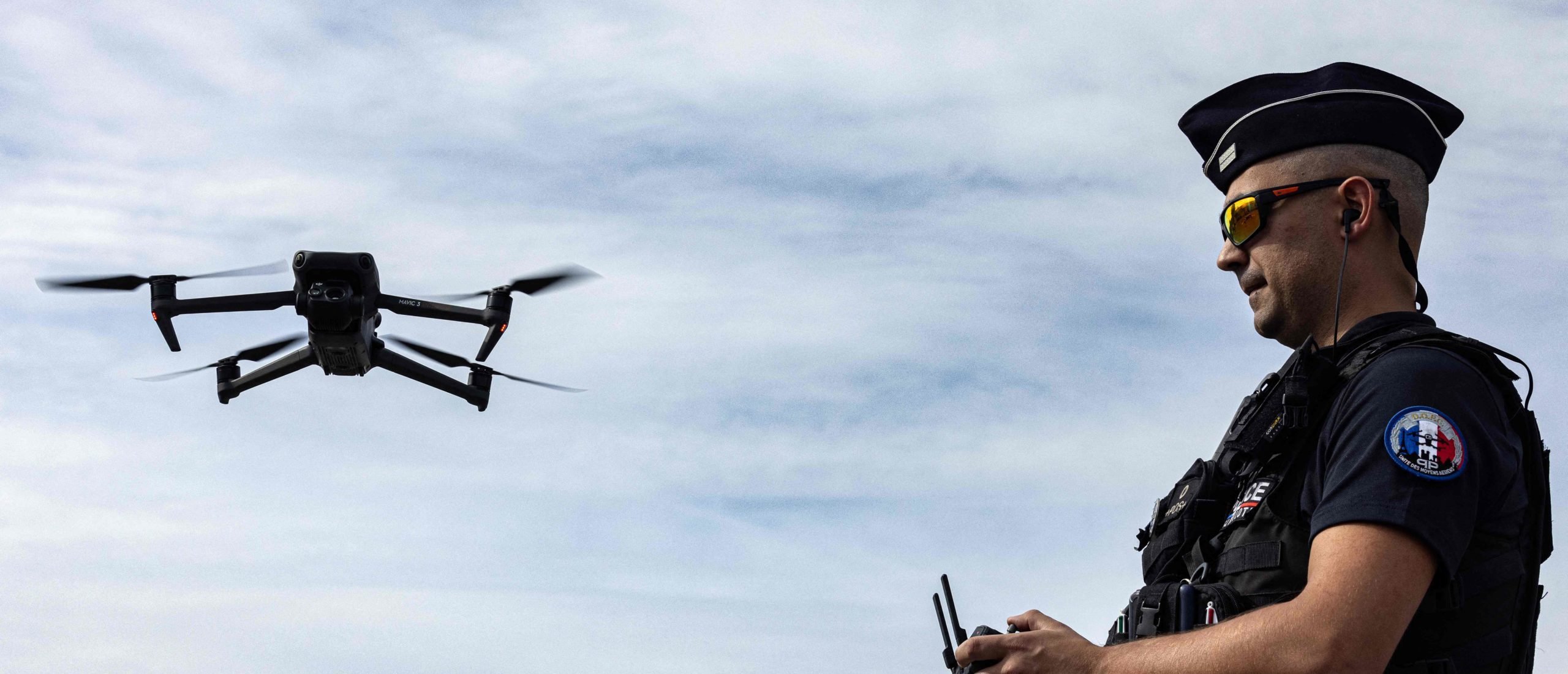 A drone remote pilot from the Air Resources unit of the Paris police prefecture trains with a flying DJI Mavric 3 Enterprise drone. (Photo by JOEL SAGET / AFP)