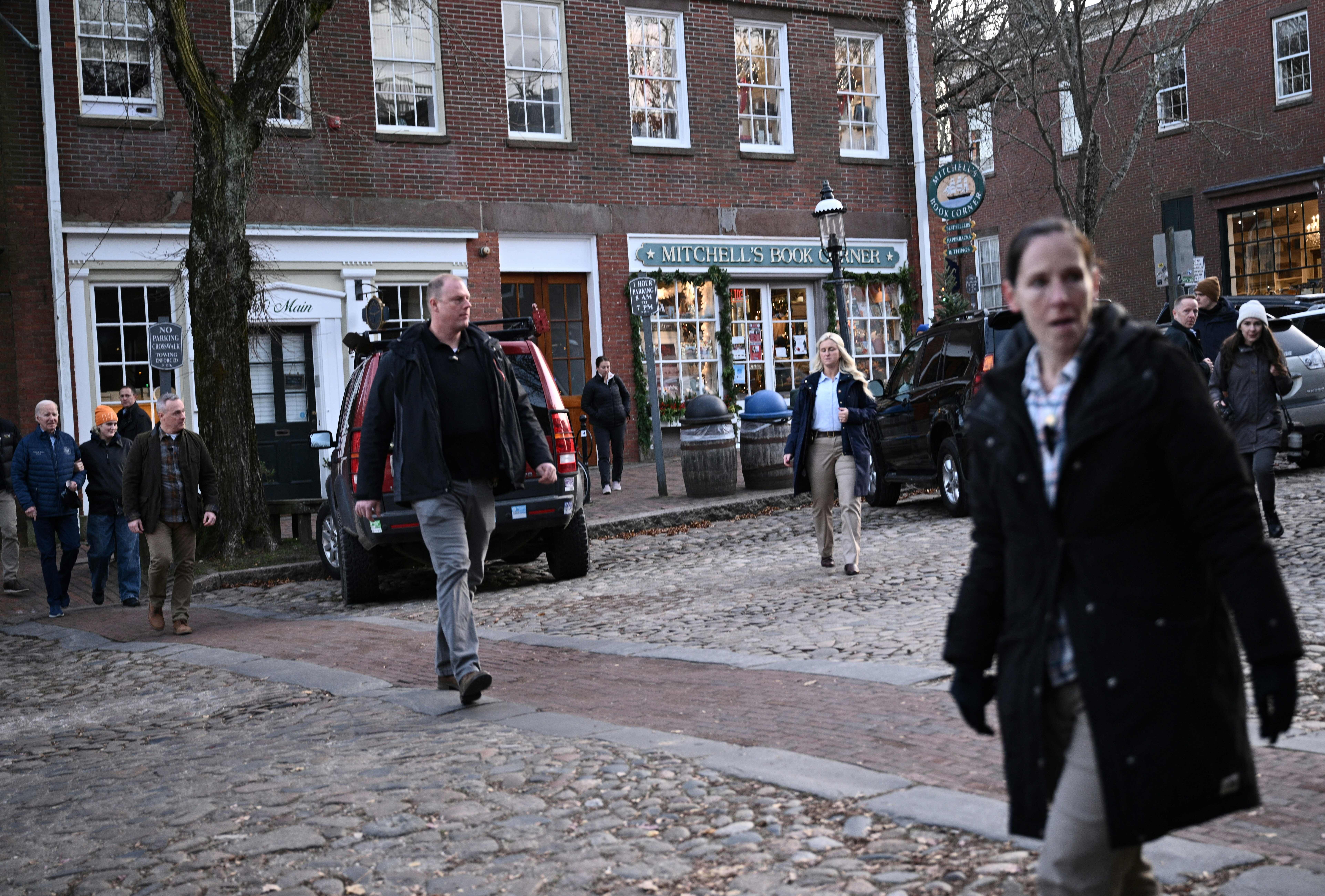 Secret Service agents walk ahead of US President Joe Biden (L) as he visits local shops with relatives in Nantucket, Massachusetts, on November 25, 2023. (Photo by BRENDAN SMIALOWSKI/AFP via Getty Images)