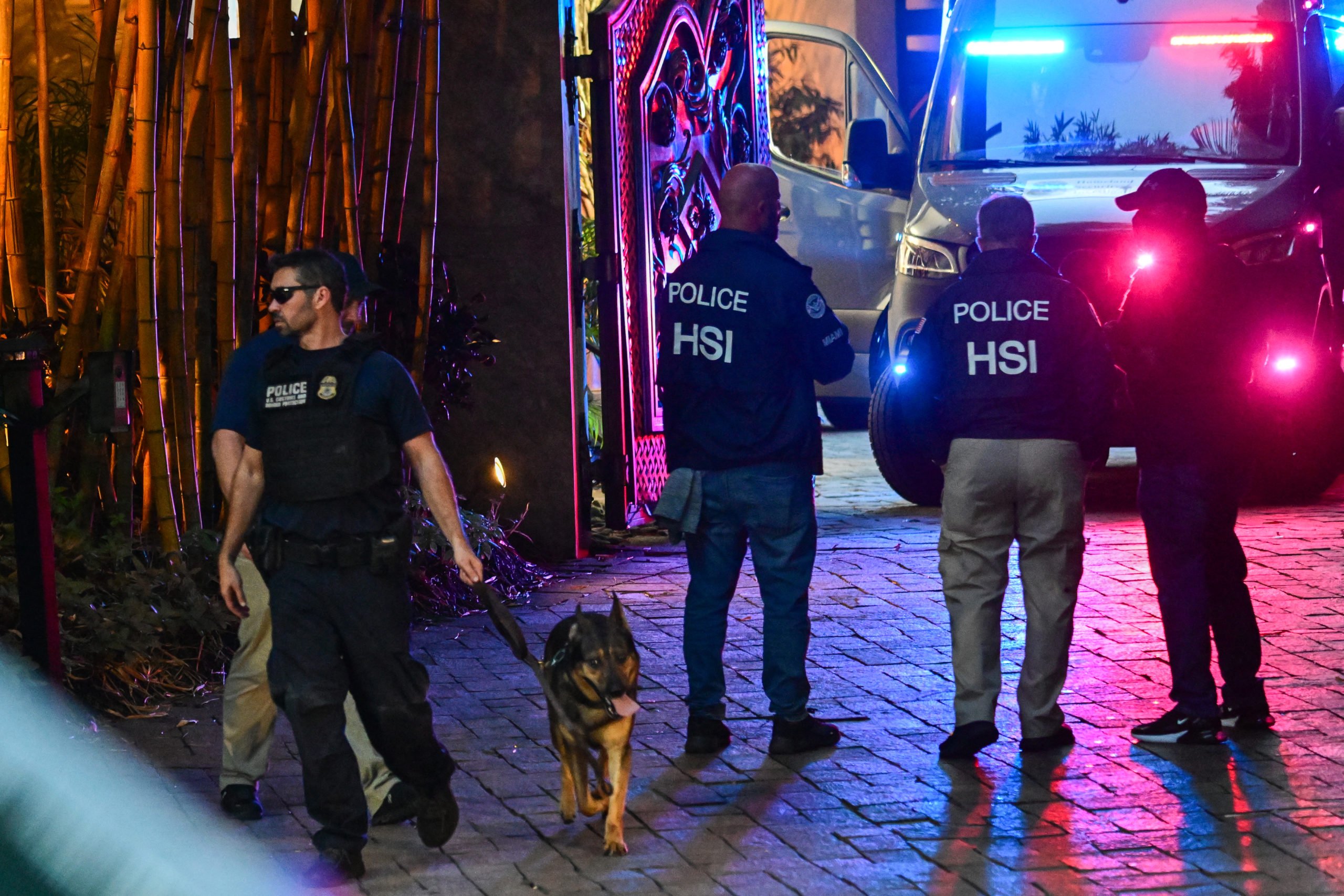 Homeland Security Investigation agents are seen at the entrance of US producer and musician Sean "Diddy" Combs's home at Star Island in Miami Beach on March 25, 2024. Homes belonging to Sean "Diddy" Combs were being raided by federal agents, media reported on March 25, with the US hip hop mogul at the center of sex trafficking and sex assault lawsuits. GIORGIO VIERA/AFP via Getty Images