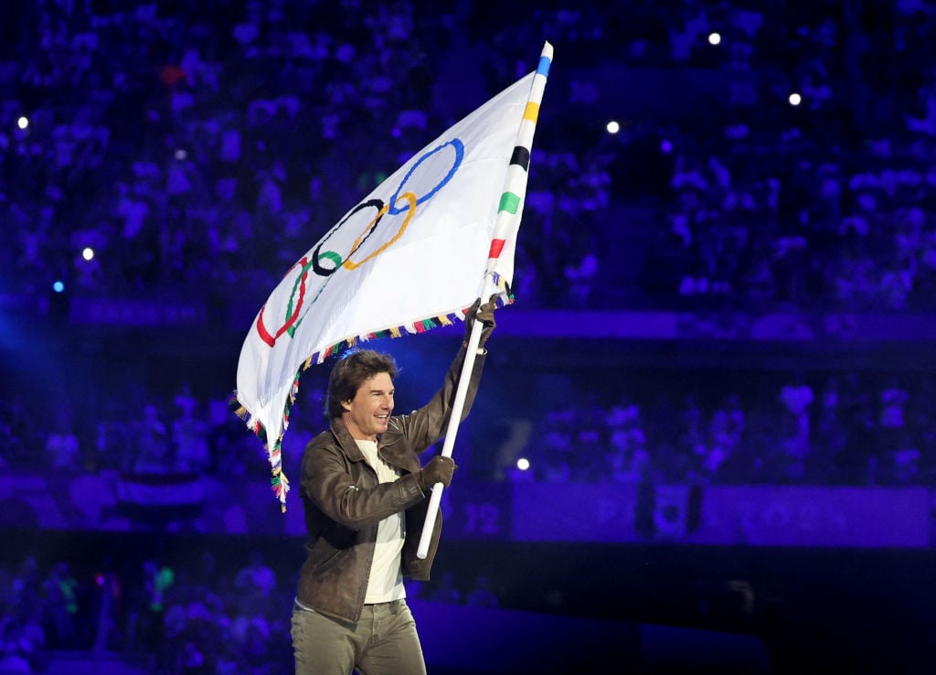 PARIS, FRANCE - AUGUST 11: Actor Tom Cruise holds the Olympic flag during the Closing Ceremony of the Olympic Games Paris 2024 at Stade de France on August 11, 2024 in Paris, France. (Photo by Fabrizio Bensch- Pool/Getty Images)