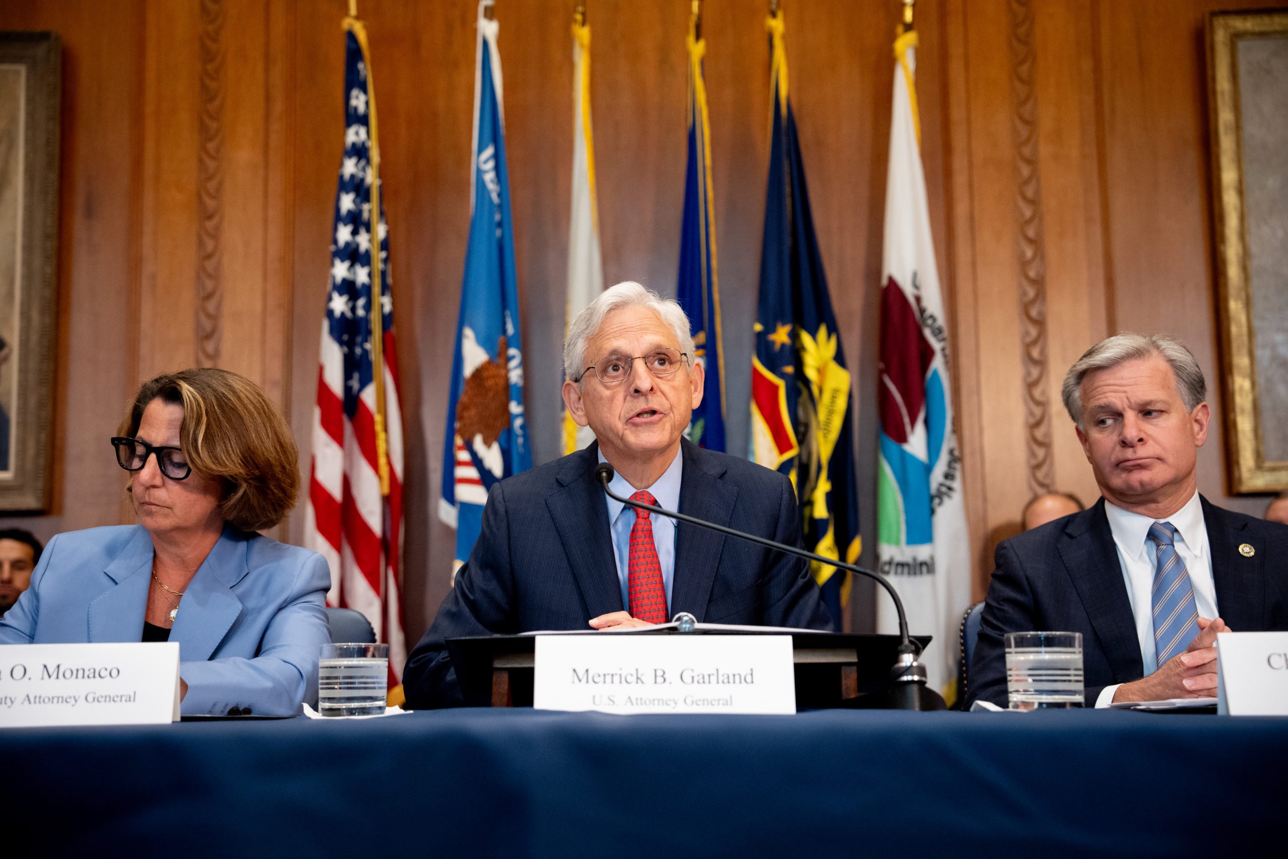 U.S. Attorney General Merrick Garland (C) accompanied by Deputy Attorney General Lisa Monaco and FBI Director Christopher Wray, speaks during an Election Threats Task Force meeting at the Justice Department on September 4, 2024 in Washington, DC. Garland, who launched the task force three years ago after a steep increase in violent threats to election workers, reaffirmed his commitment to safeguarding election workers domestically and also announced two actions against Russia for attempted covert influence operations. (Photo by Andrew Harnik/Getty Images)