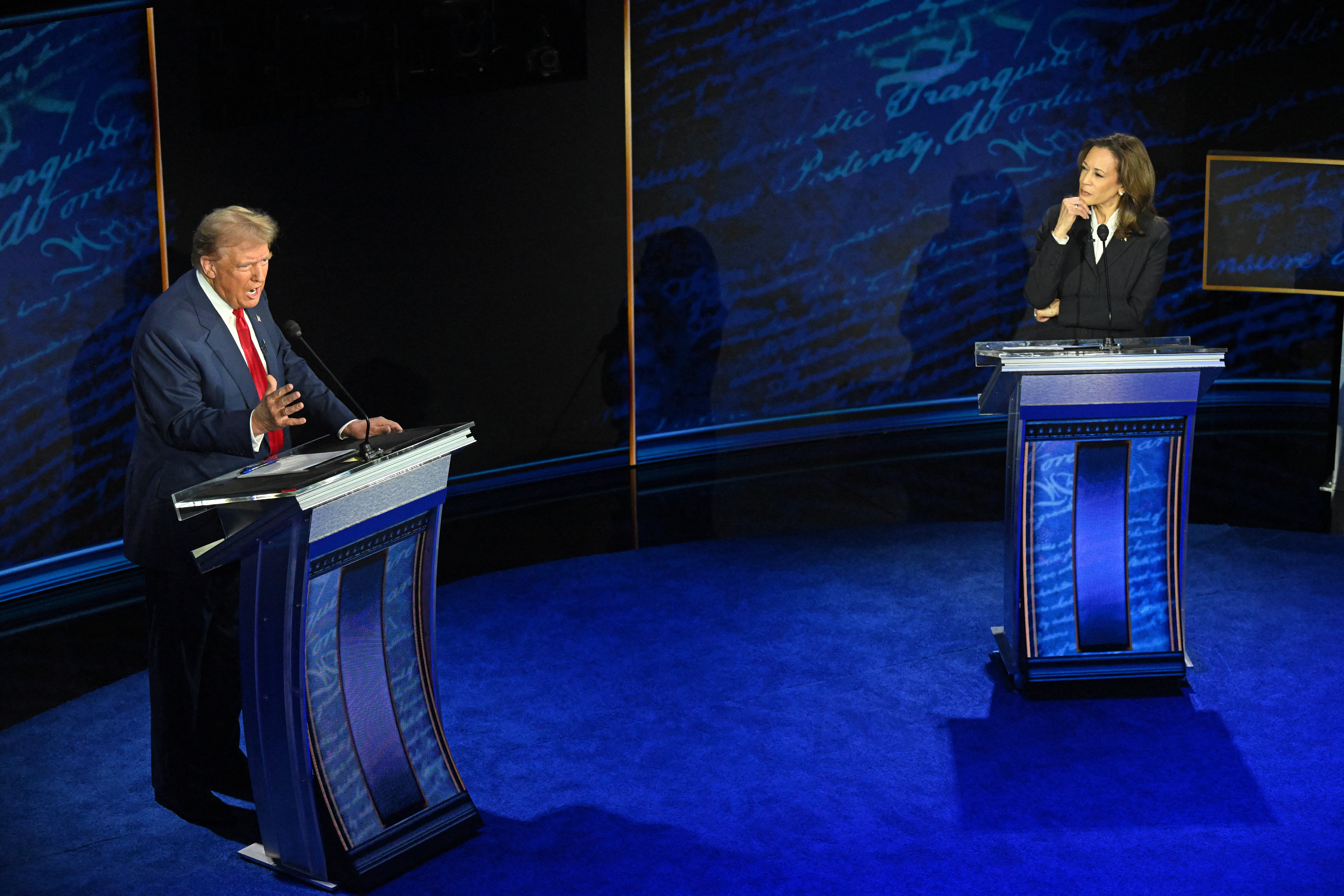 US Vice President and Democratic presidential candidate Kamala Harris listens as former US President and Republican presidential candidate Donald Trump speaks during a presidential debate at the National Constitution Center in Philadelphia, Pennsylvania, on September 10, 2024. (Photo by SAUL LOEB / AFP) (Photo by SAUL LOEB/AFP via Getty Images)