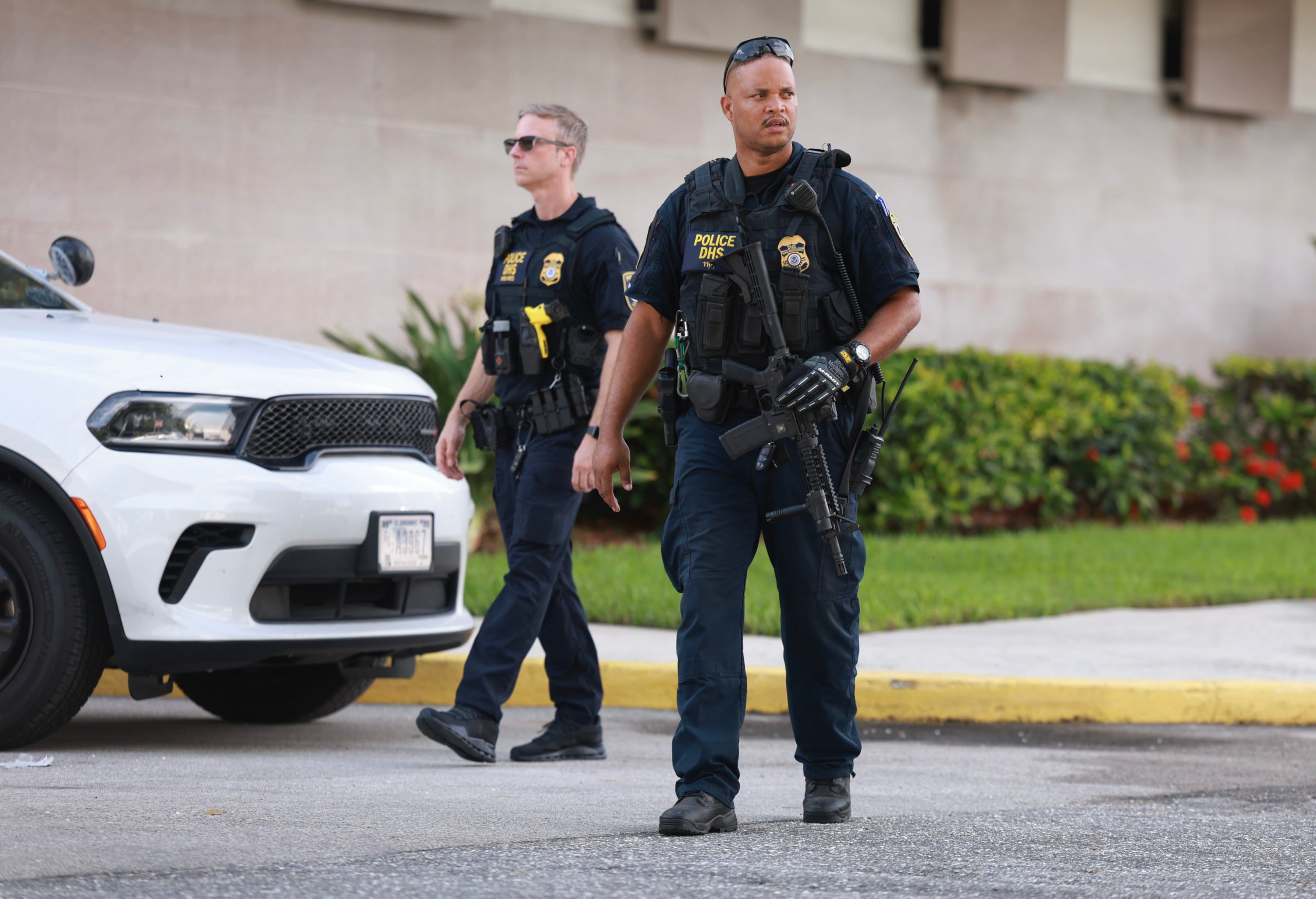 WEST PALM BEACH, FLORIDA - SEPTEMBER 16: Members of the Department of Homeland Security, Federal Protective Service police provide security as Ryan Wesley Routh, the suspect in the apparent assassination attempt on Donald Trump, is brought before a judge at the federal courthouse for an initial appearance on September 16, 2024, in West Palm Beach, Florida. It has been reported that Routh is currently facing two charges: possession of a firearm by a prohibited person/convicted felon, along with possession of a weapon with an obliterated serial number. The FBI and U.S. Secret Service, along with the Palm Beach County Sheriff's office, are investigating the incident, which the FBI said "appears to be an attempted assassination of former President Trump" while he was golfing at Trump International Golf Club. (Photo by Joe Raedle/Getty Images)