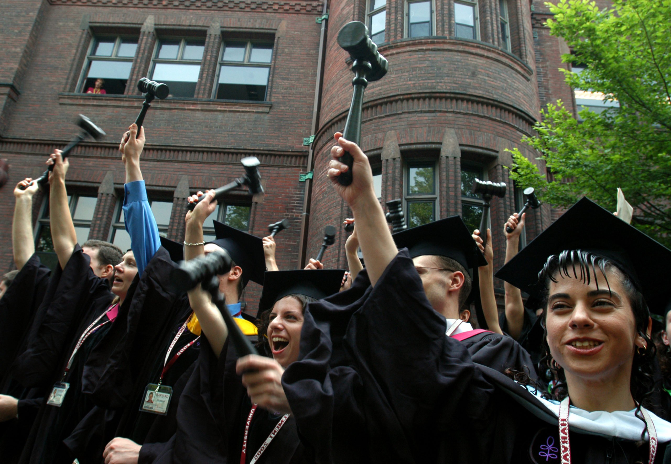 CAMBRIDGE, MA -JUNE 9: Harvard Law School graduates celebrate by waving gavels during Harvard University Commencement exercises in June 9, 2005 in Cambridge, Massachusetts. (Photo by William B. Plowman/Getty Images)